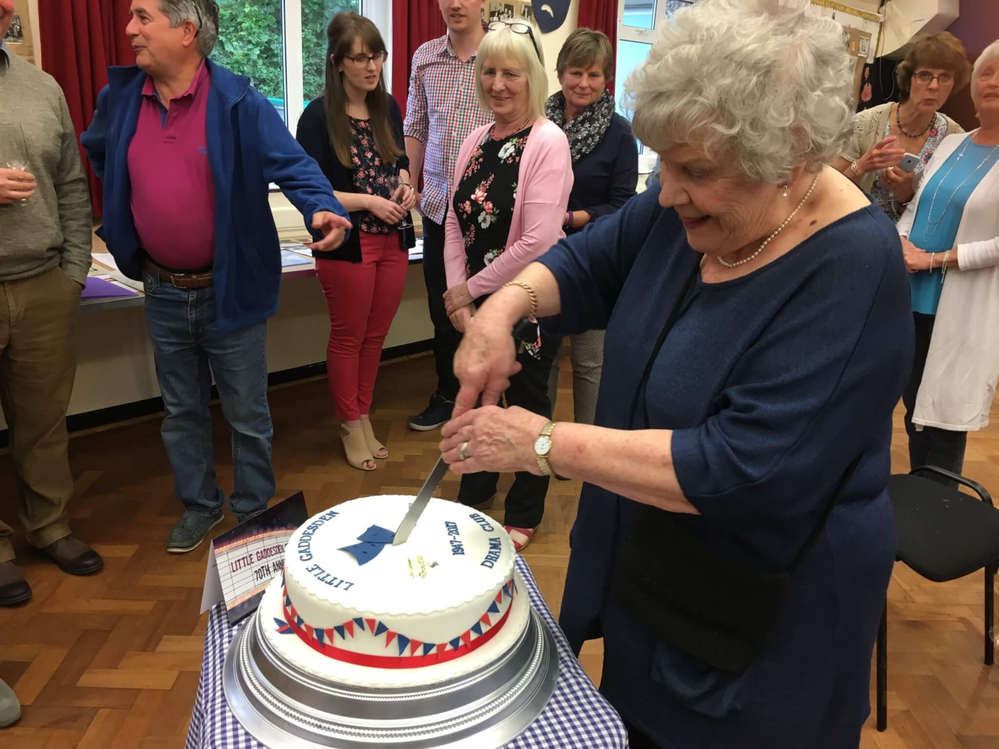 Photo of Patsy Blackmore cutting cake